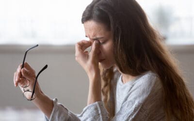 woman suffering dry eye syndrome and rubbing eyes