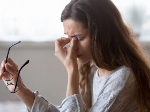 woman suffering dry eye syndrome and rubbing eyes