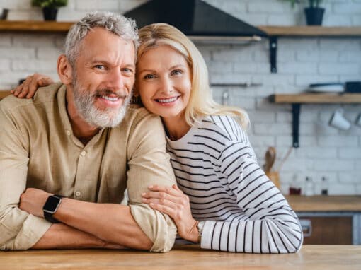 Happy middle age couple in Pittsburgh considers effects of hearing loss on brain health.