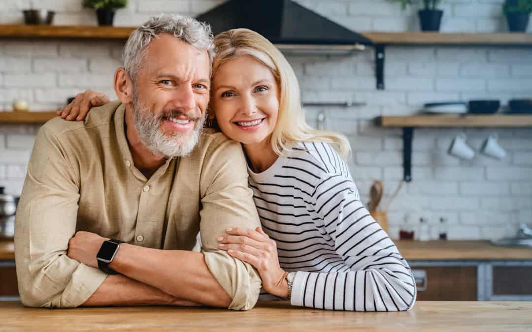 Happy middle age couple in Pittsburgh considers effects of hearing loss on brain health.