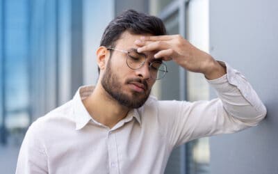 Man in Pittsburgh suffering from effects of eye strain headache.