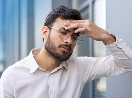 Man in Pittsburgh suffering from effects of eye strain headache.
