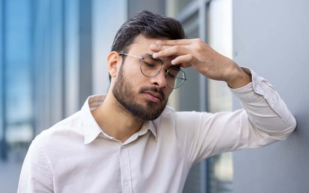 Man in Pittsburgh suffering from effects of eye strain headache.