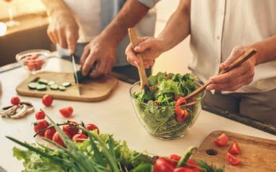 Adults in Pittsburgh preparing healthy meal to help prevent hearing loss.
