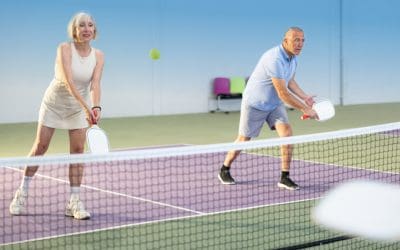 Senior couple with clear vision in Pittsburgh playing pickleball.