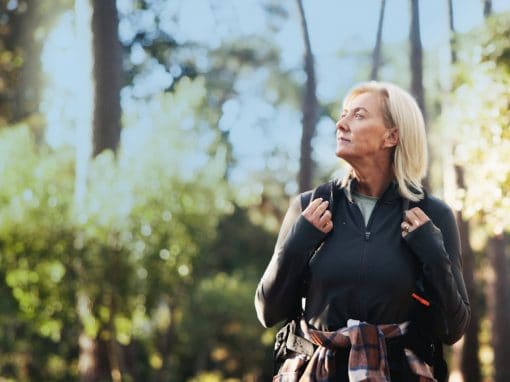 Senior woman hiking and staying active for healthy vision,