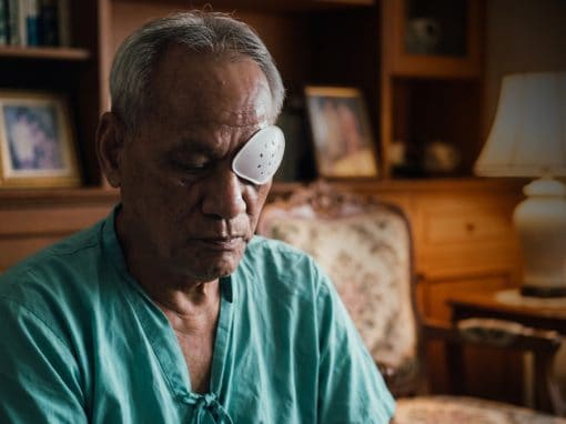 Elderly man recovering from cataract surgery.